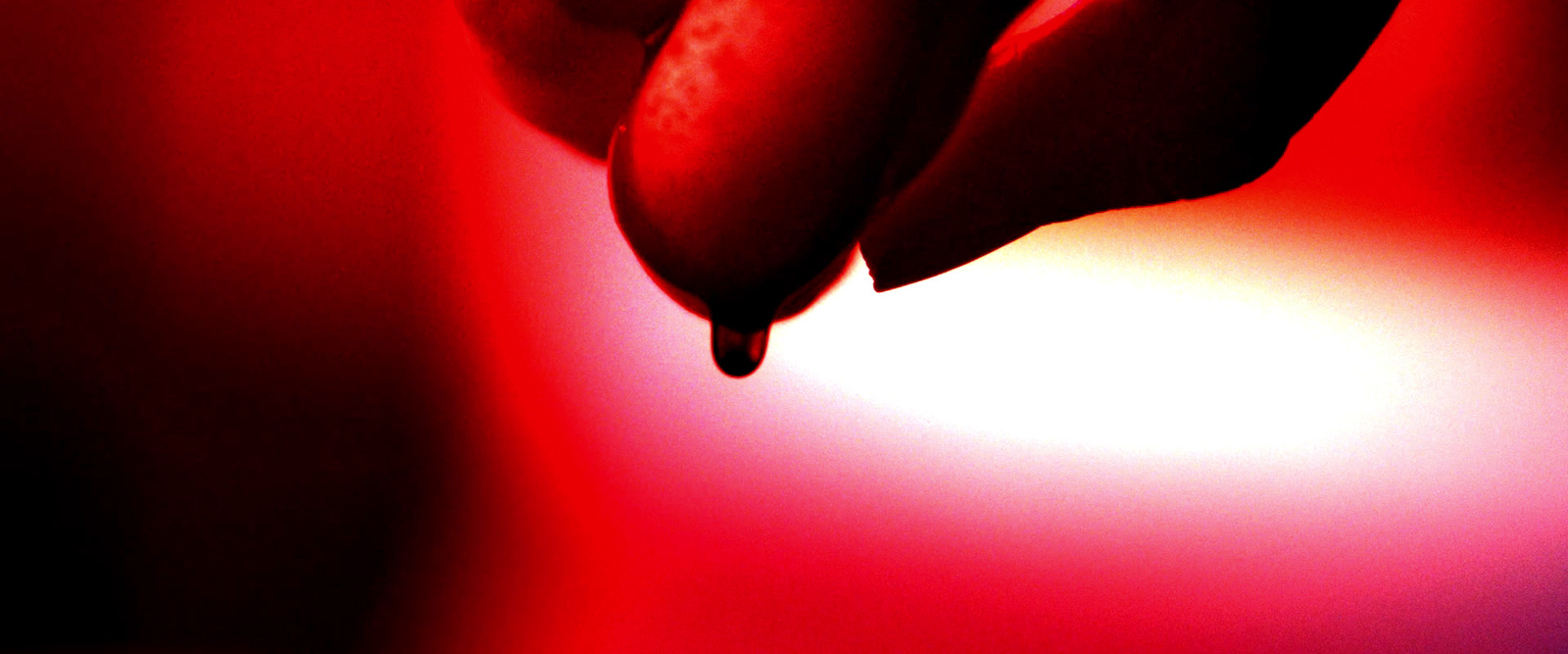 a close up of a person's hand holding a banana