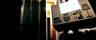 a cardboard box sitting on top of a bed