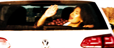 a woman sitting in the passenger seat of a car