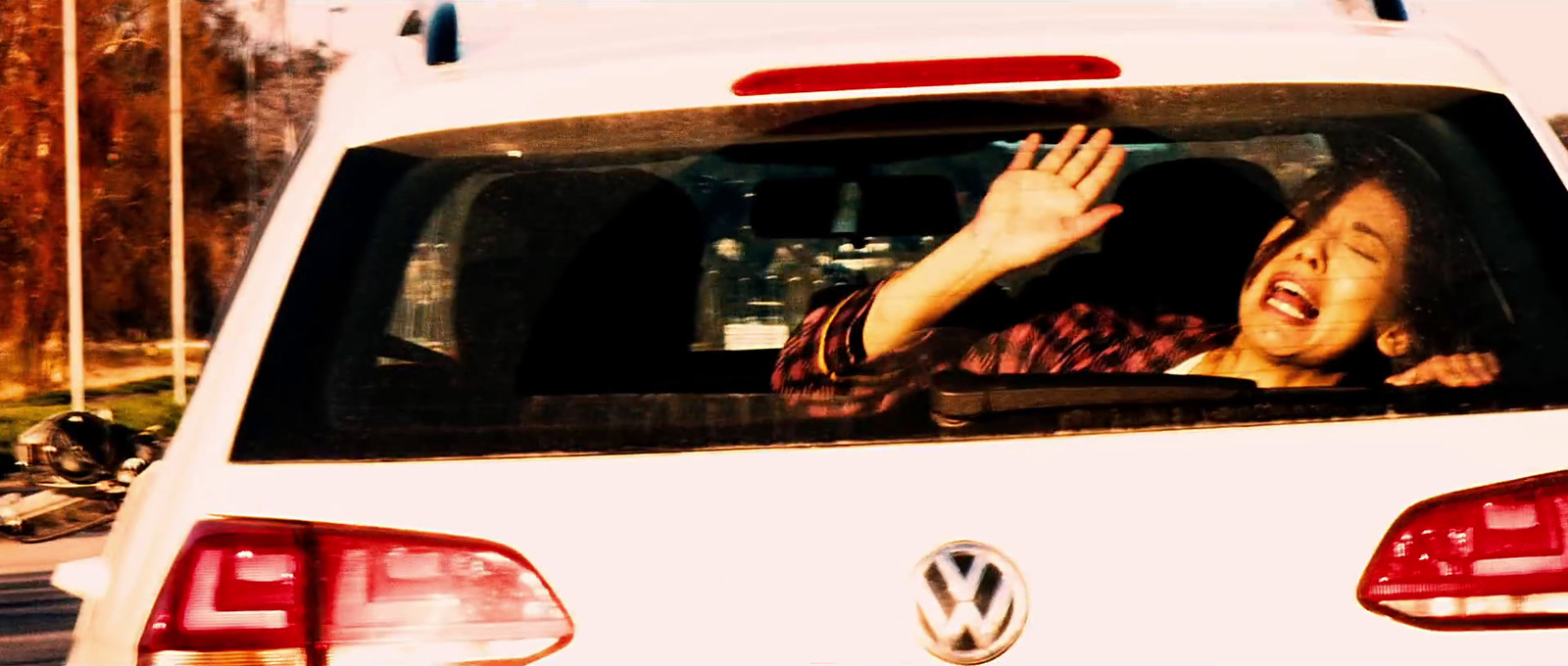 a woman sitting in the back of a white car