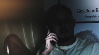 a man talking on a cell phone in a dark room