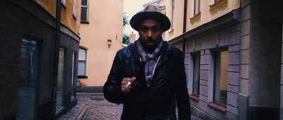 a man walking down a narrow alley way