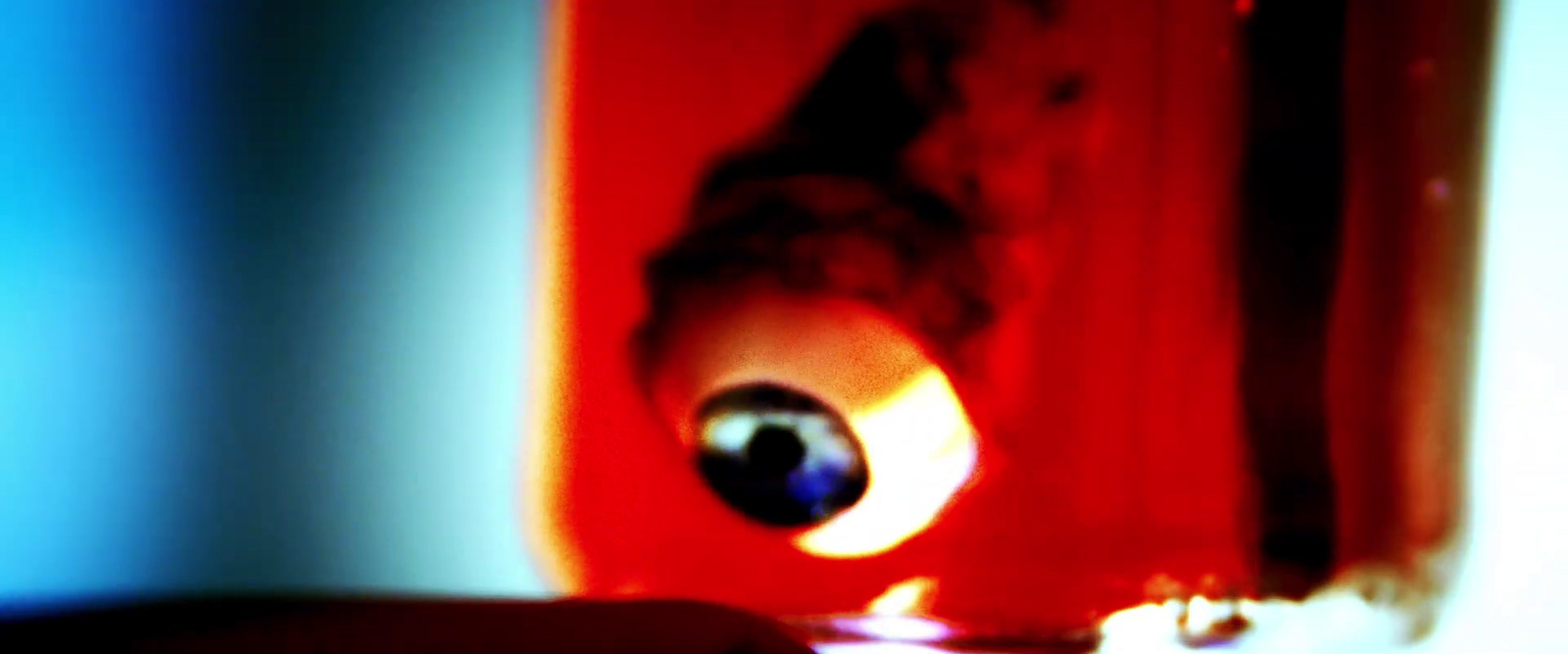 a blurry photo of a person's eye in a jar