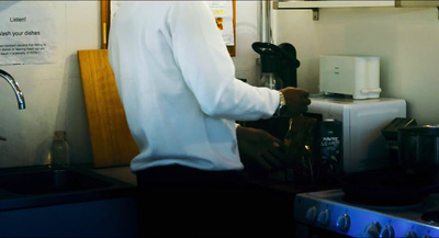 a man standing in a kitchen preparing food