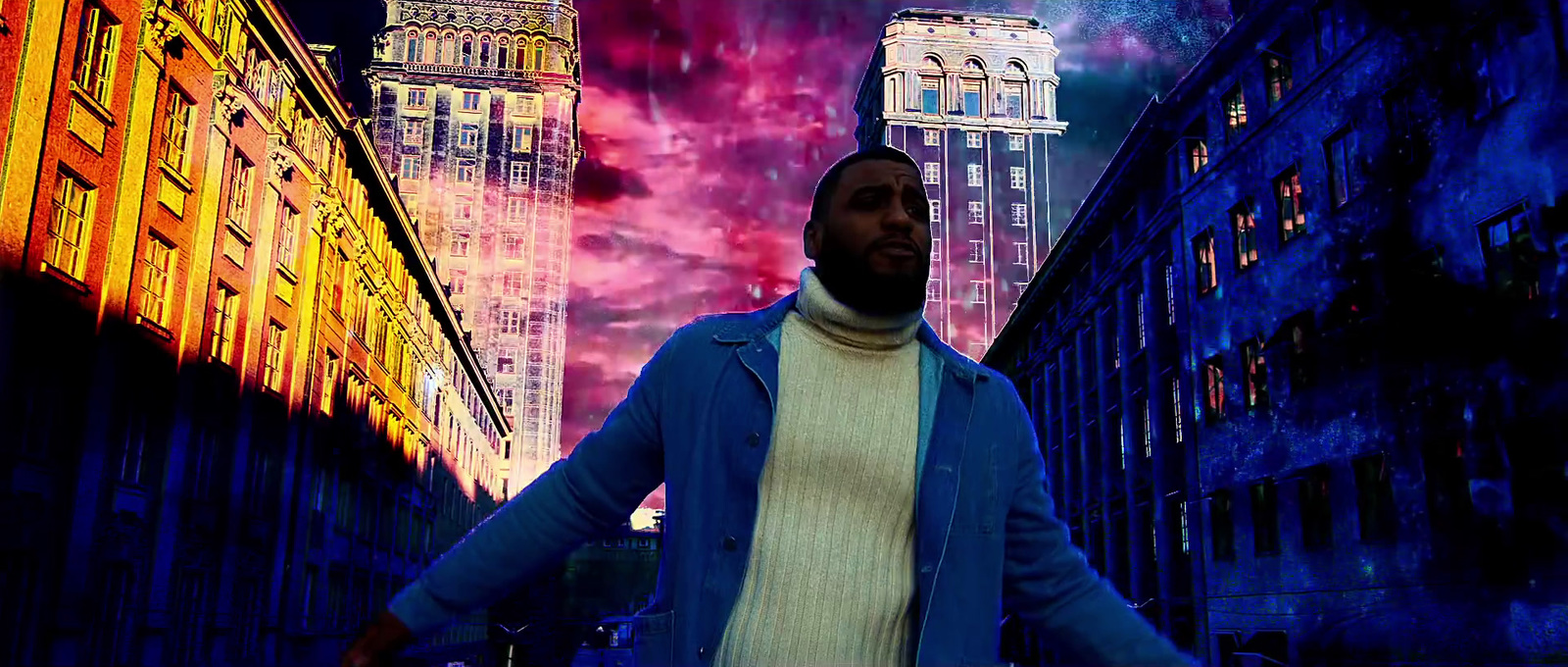 a man in a blue jacket standing in a city