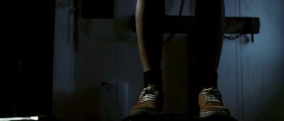 a person standing on a stool in a dark room