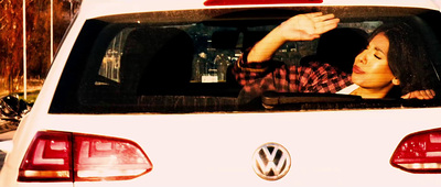 a woman sitting in the back of a white car