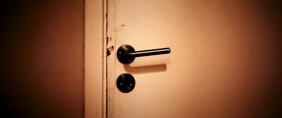 a door handle on a white door with a black handle