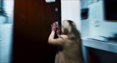 a blurry photo of a woman holding a cell phone