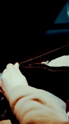 a person's feet resting on a luggage bag