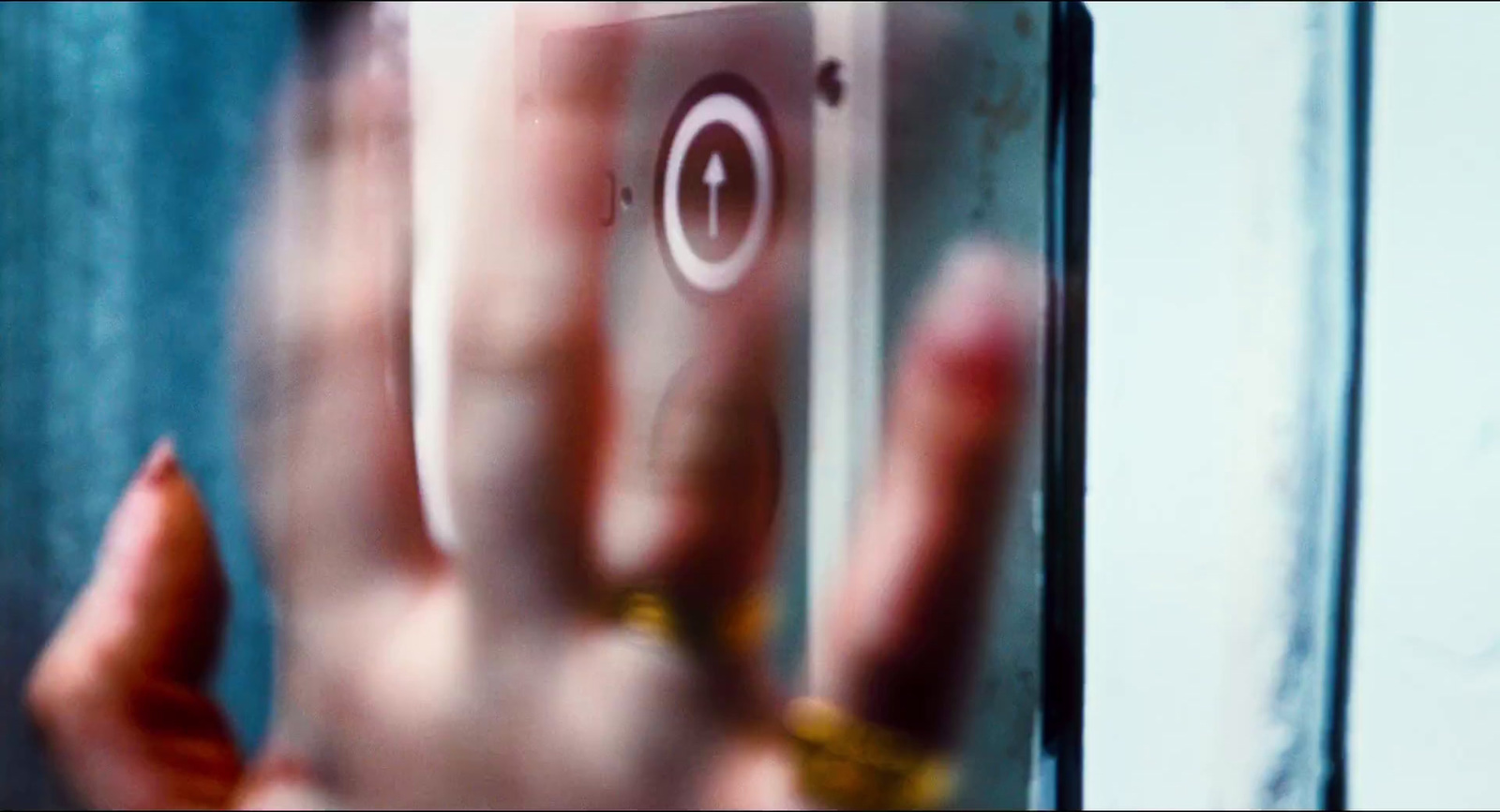 a person holding a cell phone in front of a mirror