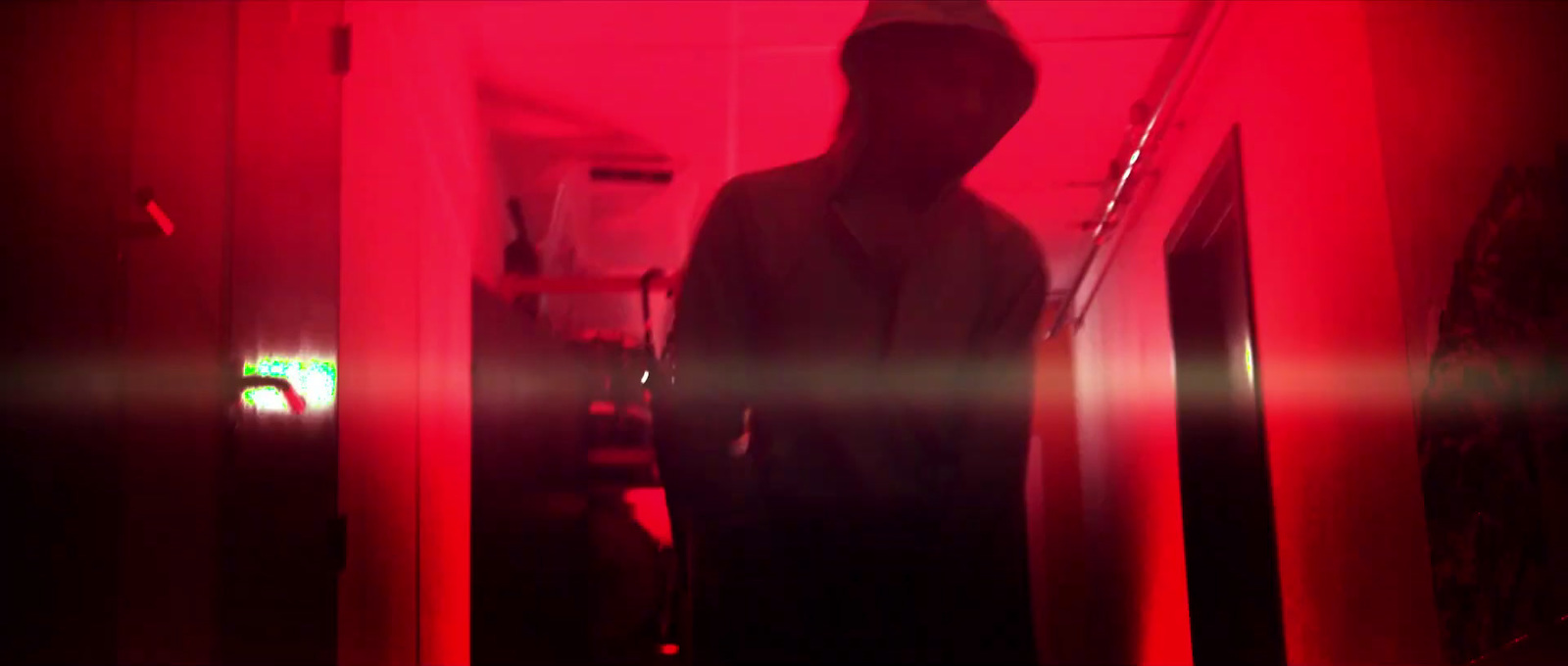 a person standing in a room with a red light