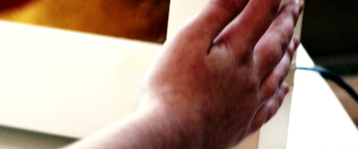 a close up of a person's hand reaching for something