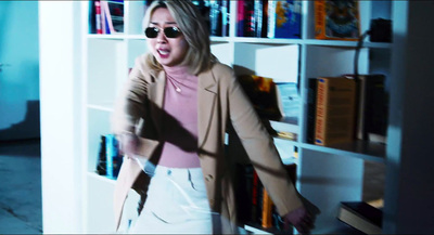 a woman standing in front of a book shelf