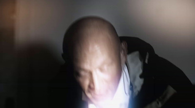 a blurry image of a man holding a cell phone