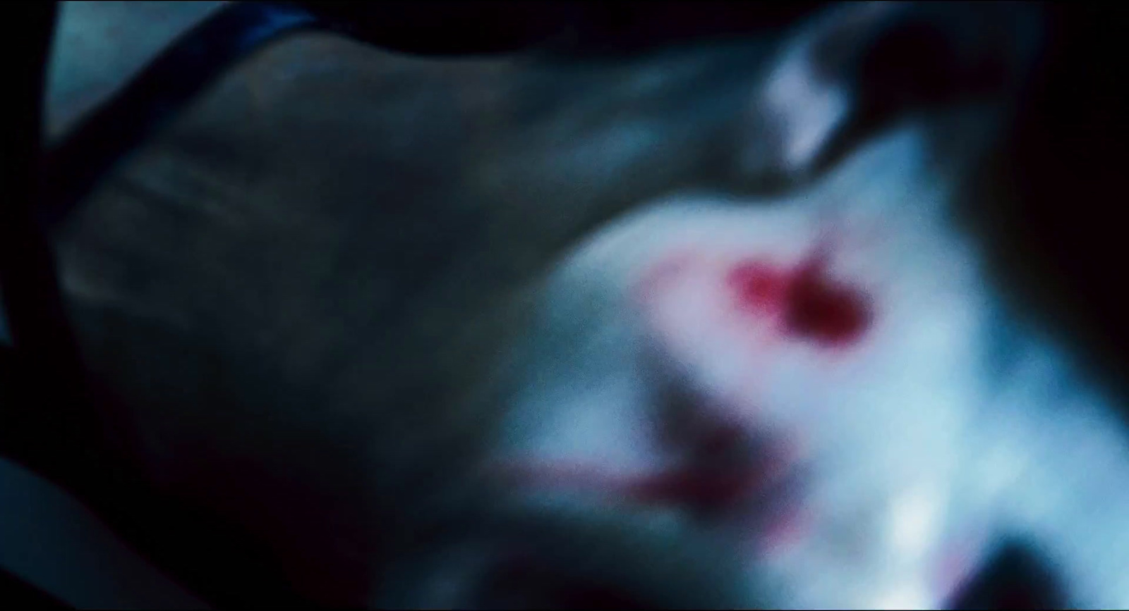 a blurry image of a person's face with blood on it