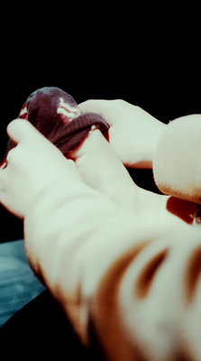 a person holding a doughnut in their hand