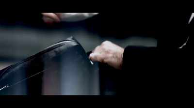 a close up of a person holding a piece of luggage