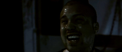 a man laughing in the dark with his mouth open