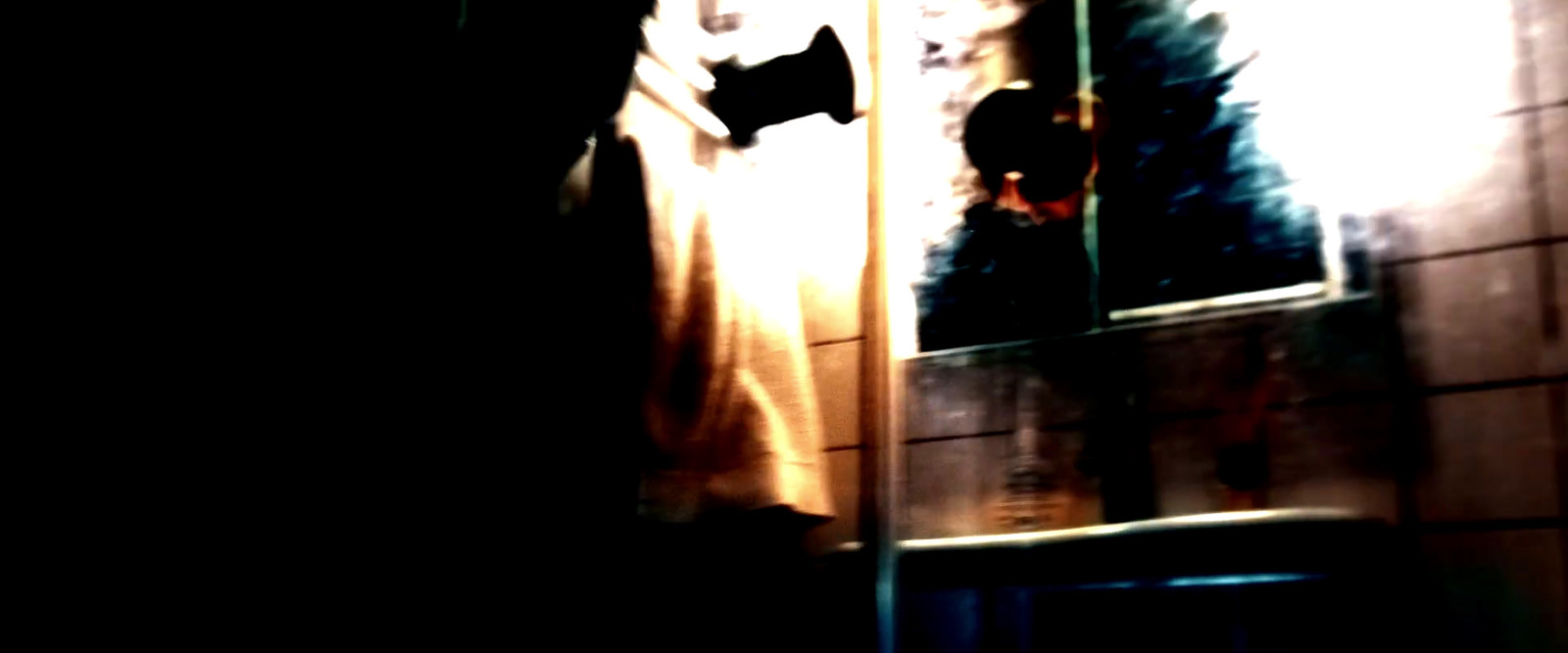 a cat sitting on a window sill in a dark room