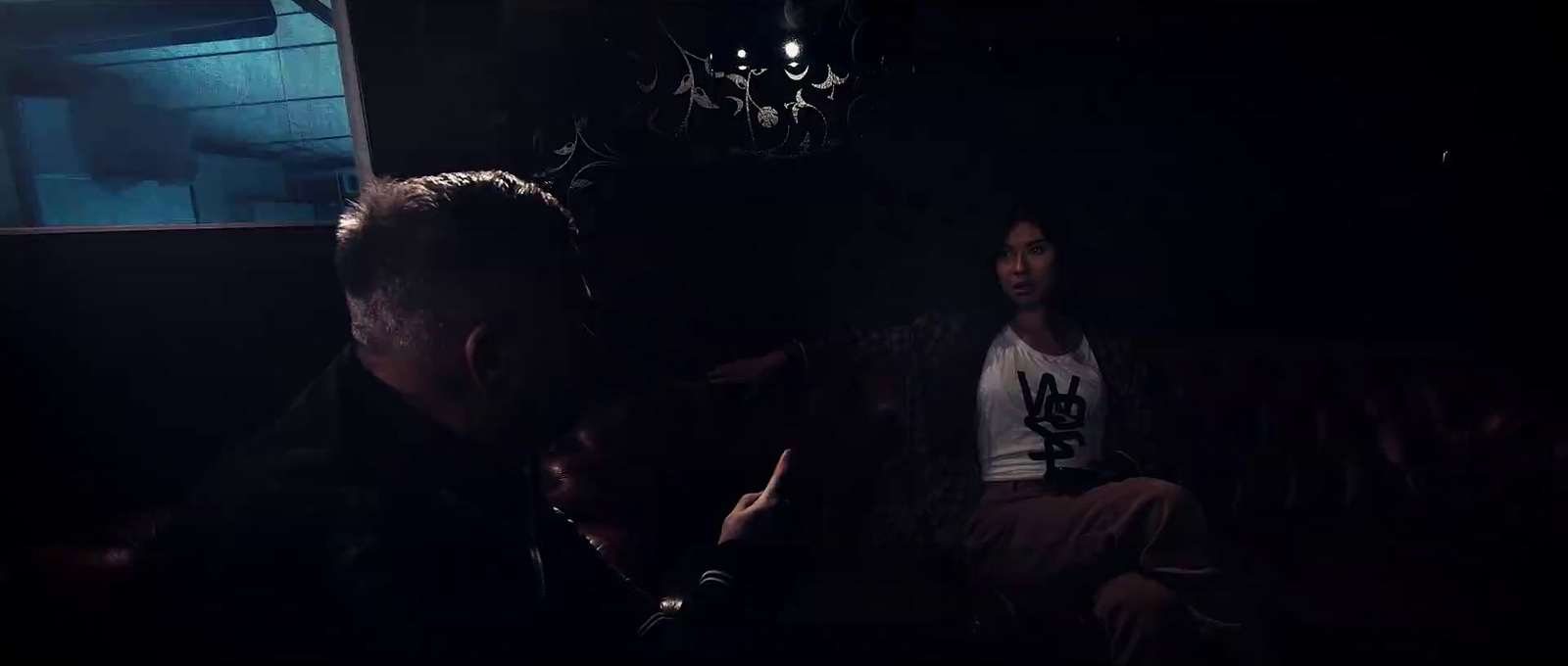 a man and a woman sitting in a dark room