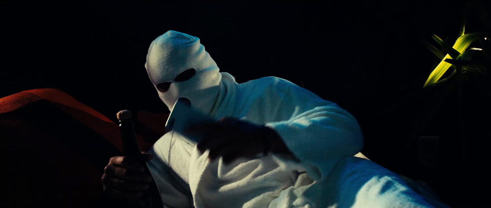 a person in a white mask holding a bat