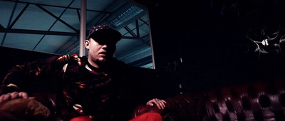 a man sitting on a couch in a dark room