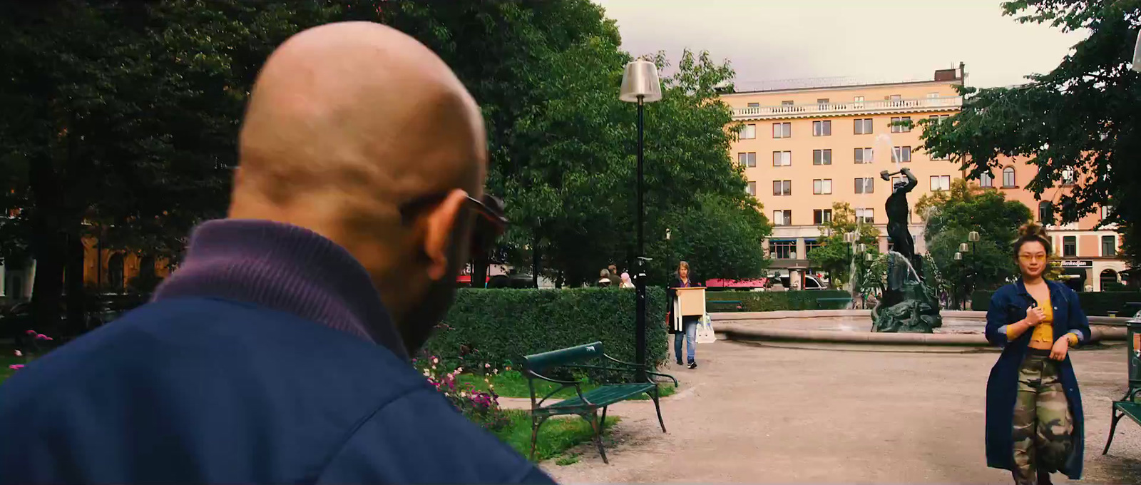 a man standing next to a woman in a park