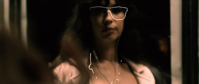 a woman wearing glasses and a white shirt