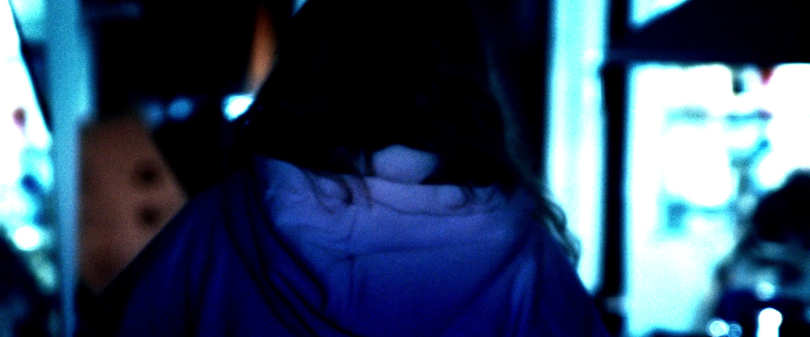 a blurry image of a woman's back in a dark room