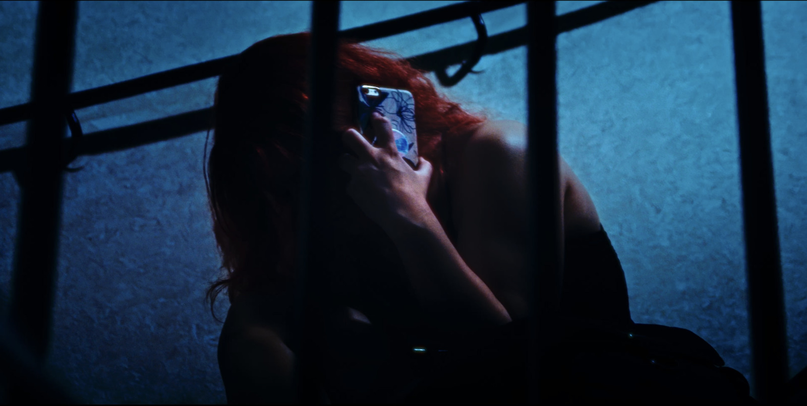 a woman holding a cell phone up to her face