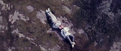 a man laying on the ground in the grass