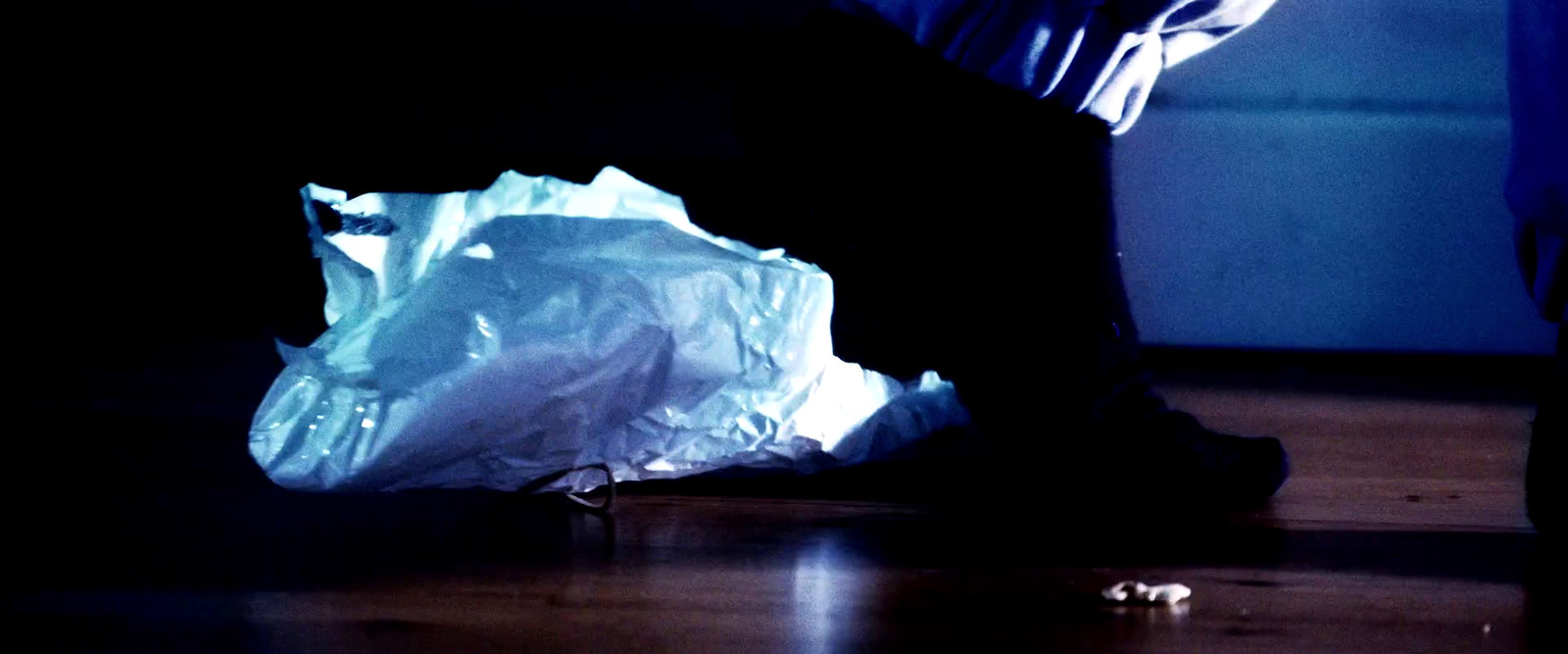 a plastic bag sitting on the floor in the dark