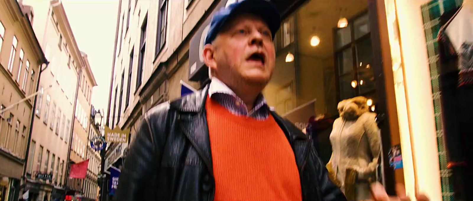 a man standing in front of a store window