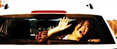 a woman sticking her head out of a car window