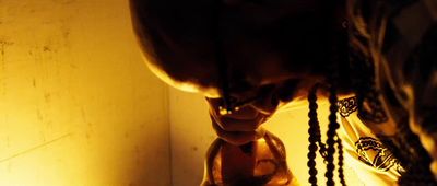 a close up of a person's face with a lamp in the background