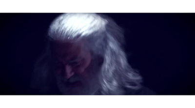 a man with long white hair and a beard