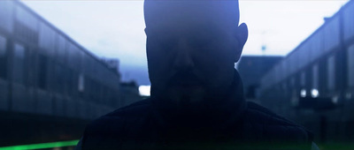 a man standing in front of a building in the dark