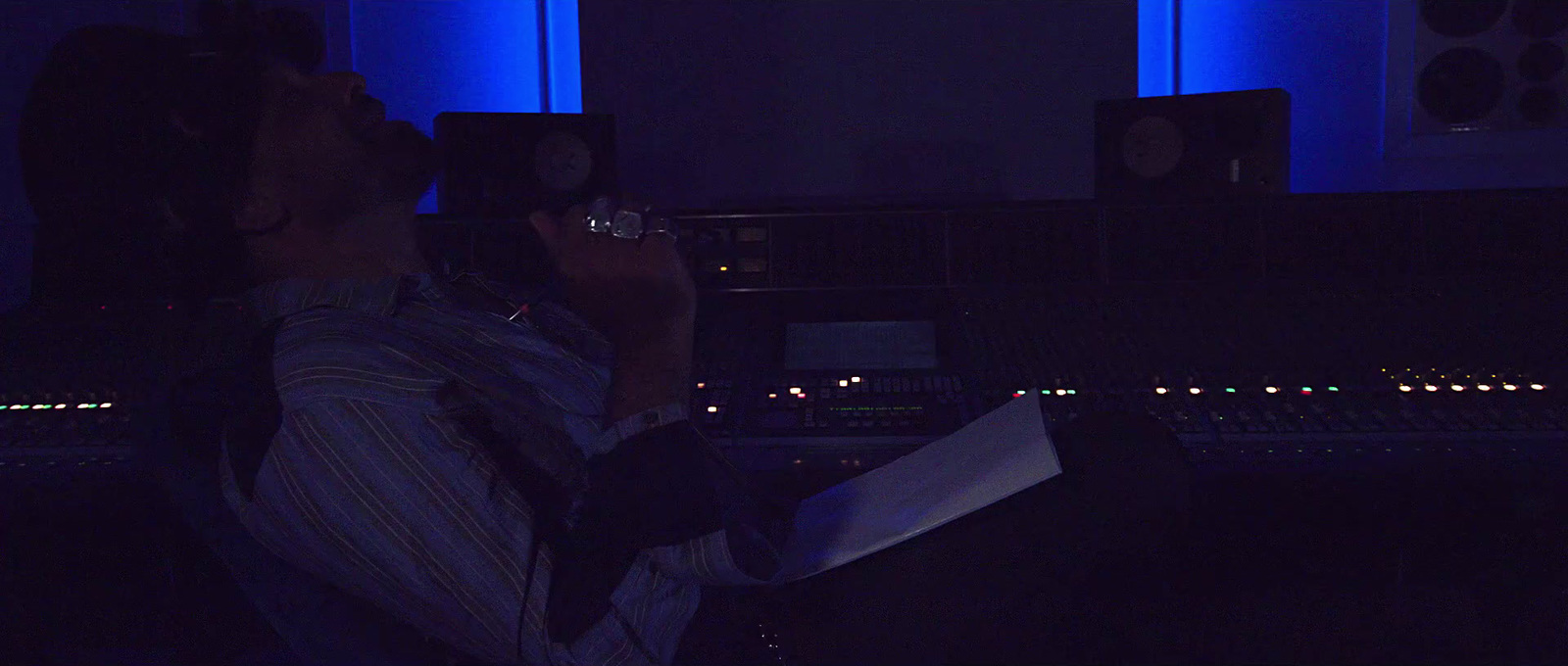 a man sitting in front of a mixing desk