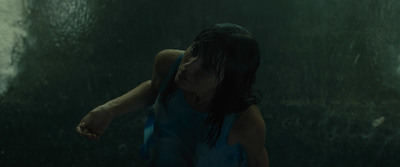 a woman standing in the rain with her hand on her face