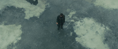 a man standing in the middle of a large body of water