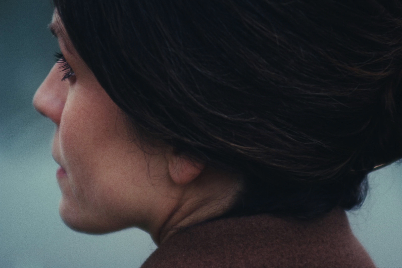 a close up of a woman's face with a blurry background