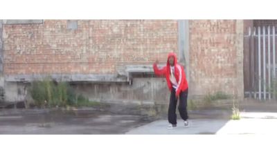 a man in a red jacket is throwing a frisbee