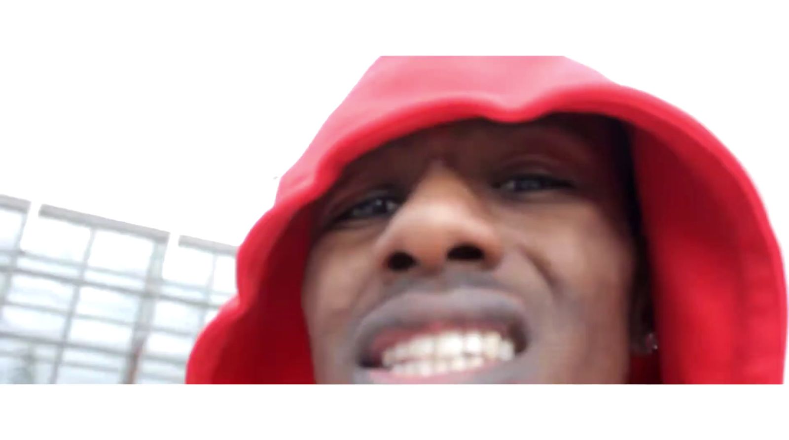 a man in a red hoodie is smiling