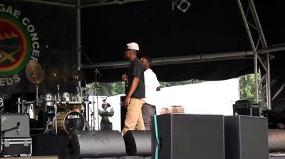 a couple of men standing on top of a stage