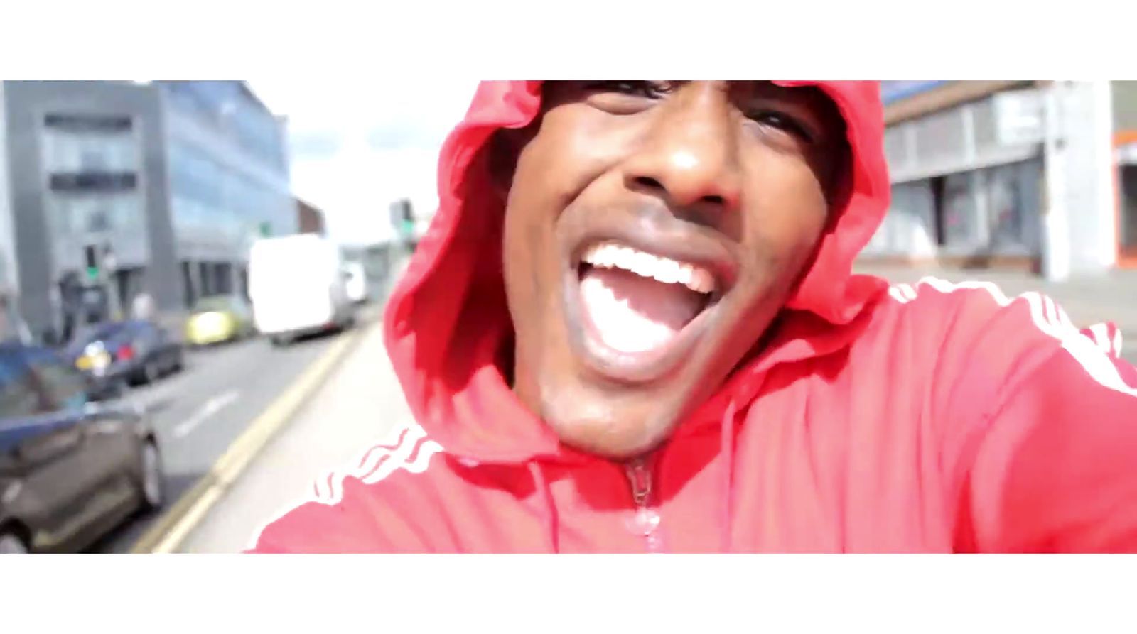 a man in a red hoodie making a funny face