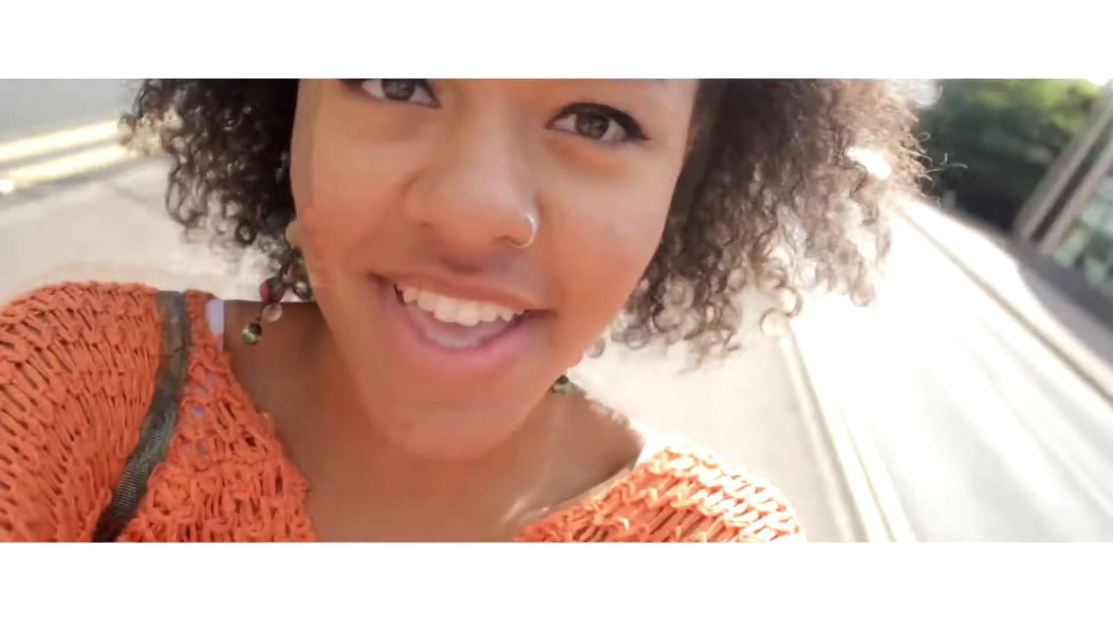 a close up of a person wearing an orange shirt