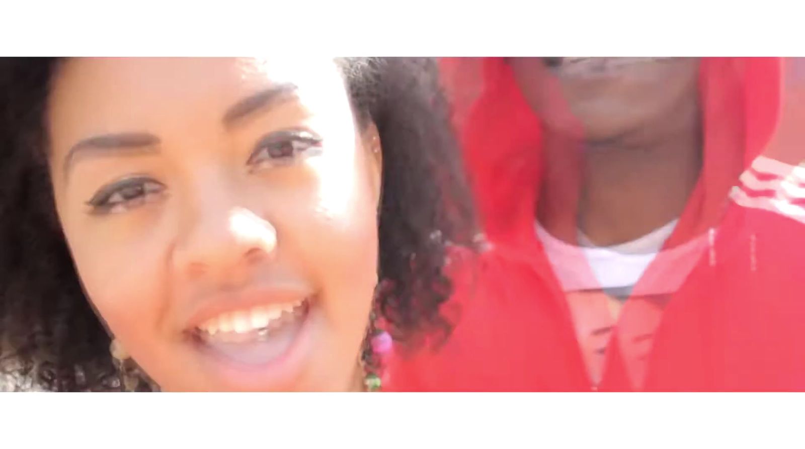 a close up of a person wearing a red hoodie