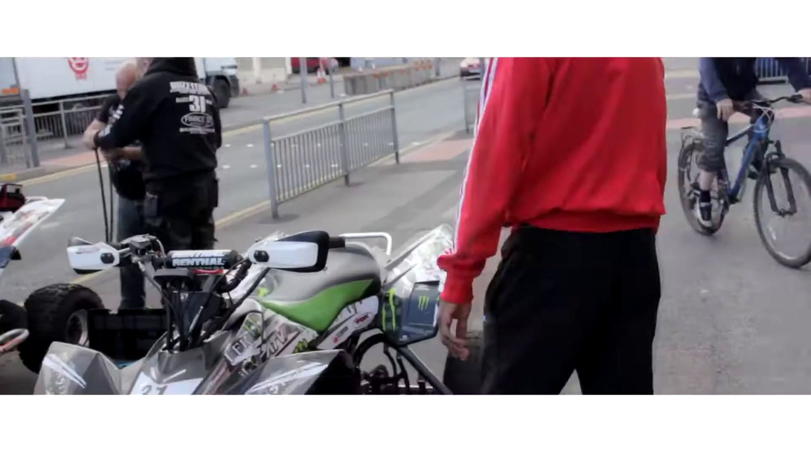 a man standing next to a motorcycle on a street