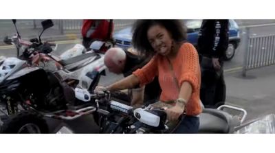 a woman riding on the back of a motorcycle